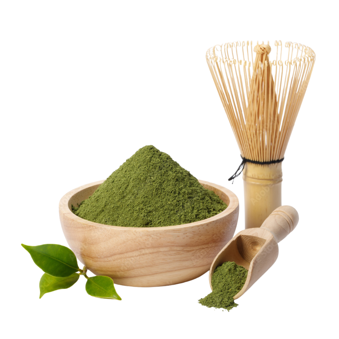 Japanese green tea matcha powder in bowl, with whisk and scoop